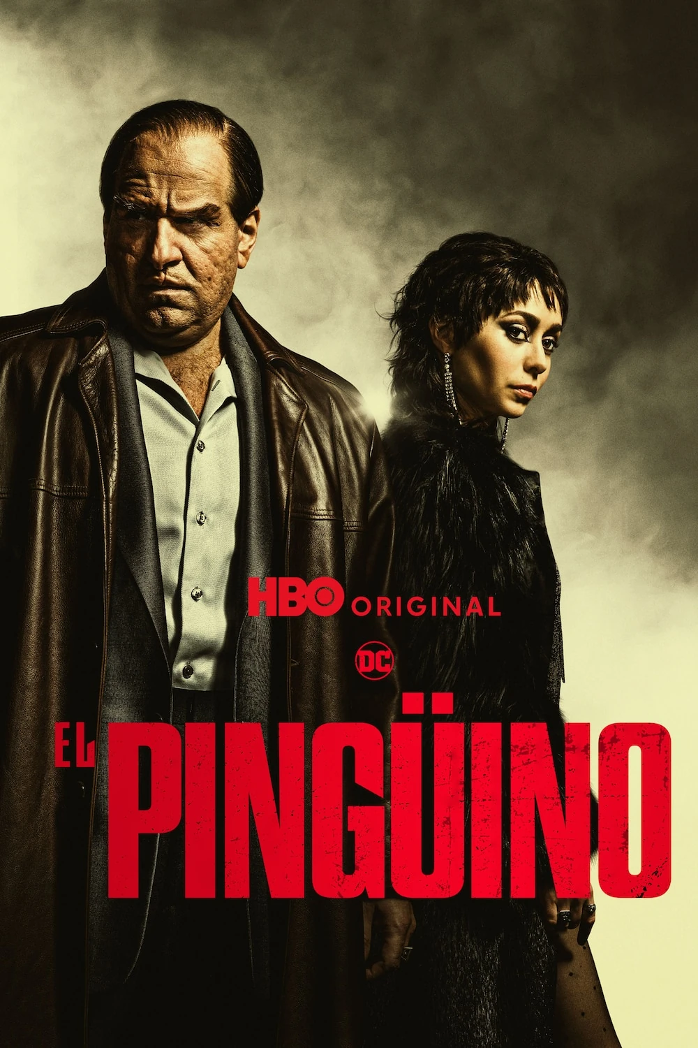 Cartel español de El Pingüino: Colin Farrell, caracterizado como Oz Cobb con abrigo de cuero, junto a Cristin Milioti, ante un cielo de humo; abajo, el título en rojo